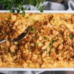 Golden baked chicken pot pie with flaky crust and savory filling, garnished with fresh parsley. Perfect comfort food dish for family dinners, featuring tender chicken and vegetables in a creamy sauce.