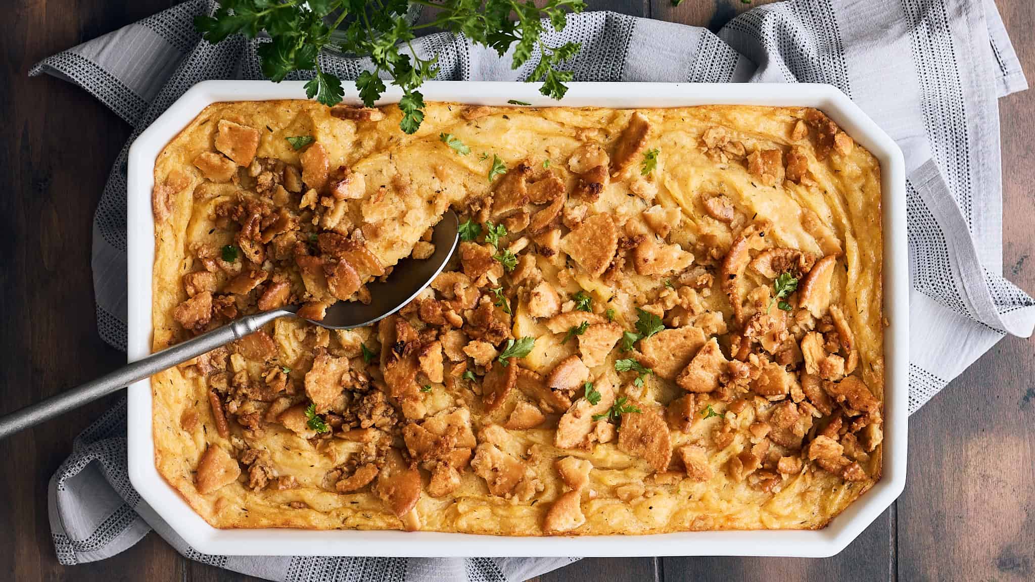 Golden baked chicken pot pie with flaky crust and savory filling, garnished with fresh parsley. Perfect comfort food dish for family dinners, featuring tender chicken and vegetables in a creamy sauce.