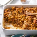Creamy chicken casserole with noodles, vegetables, and flavorful sauce in a white baking dish, ready to serve.