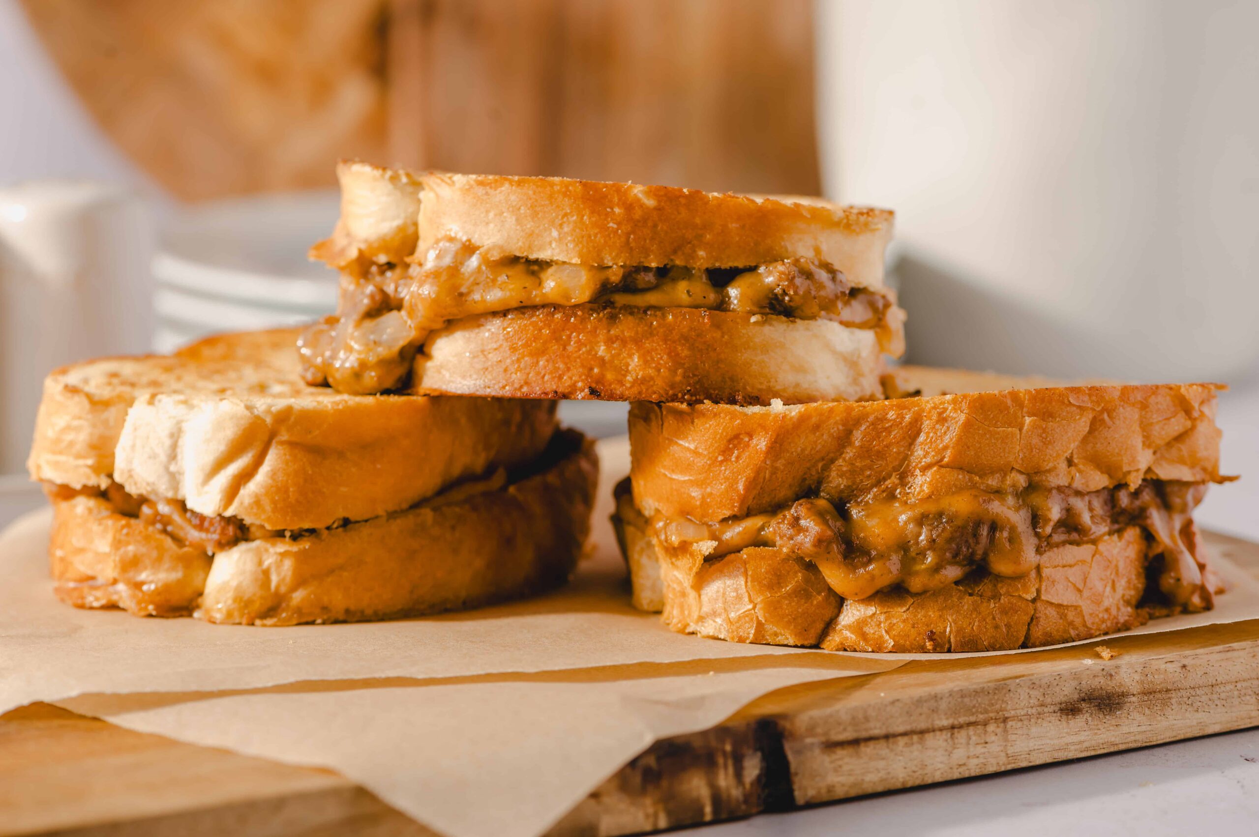 Hearty grilled cheese sandwiches with melted cheese and savory fillings on toasted bread, perfect for comfort food lovers.