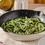 Fresh green bean pasta with grated cheese in a skillet, perfect for a healthy and delicious meal. Featured on Hey Recipe website, ideal for homemade Italian cuisine.