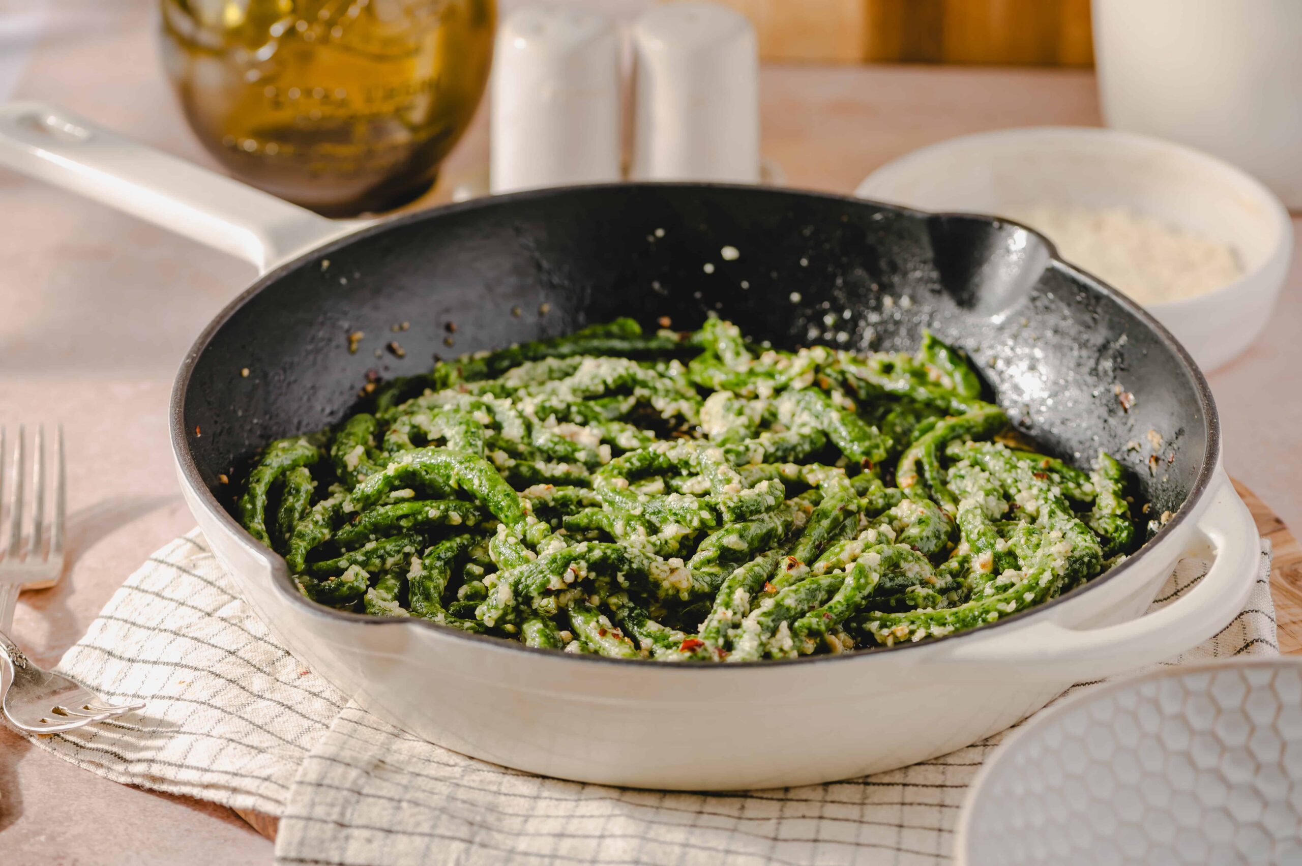 Fresh green bean pasta with grated cheese in a skillet, perfect for a healthy and delicious meal. Featured on Hey Recipe website, ideal for homemade Italian cuisine.