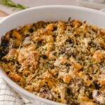 Baked vegetable and cheese casserole topped with breadcrumbs and herbs in a white ceramic baking dish, ready to serve.