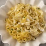 Butter garlic fettuccine pasta with parsley in a white bowl, close-up shot, creamy Italian pasta recipe, homemade pasta dish, restaurant-quality comfort food, Hey Recipe.