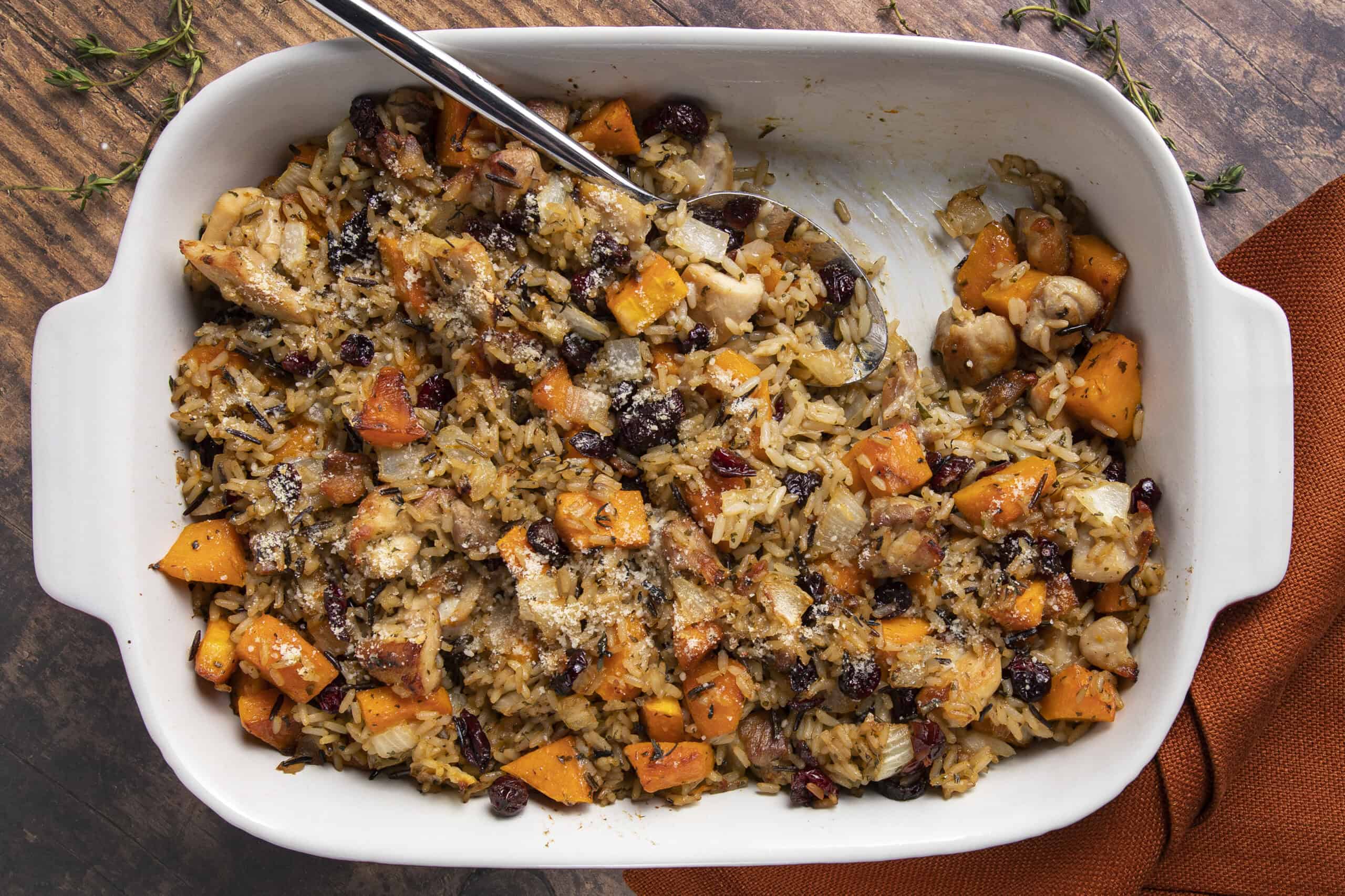 Creamy vegetable rice casserole with sweet potatoes, black beans, and chicken in a white baking dish. Healthy, flavorful, and easy-to-make comfort food perfect for family dinners.