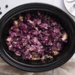 Fresh blueberry cobbler in a slow cooker with a golden brown crust, served as a warm fruit dessert. Perfect for making easy, delicious blueberry cobbler at home with fresh or frozen blueberries.