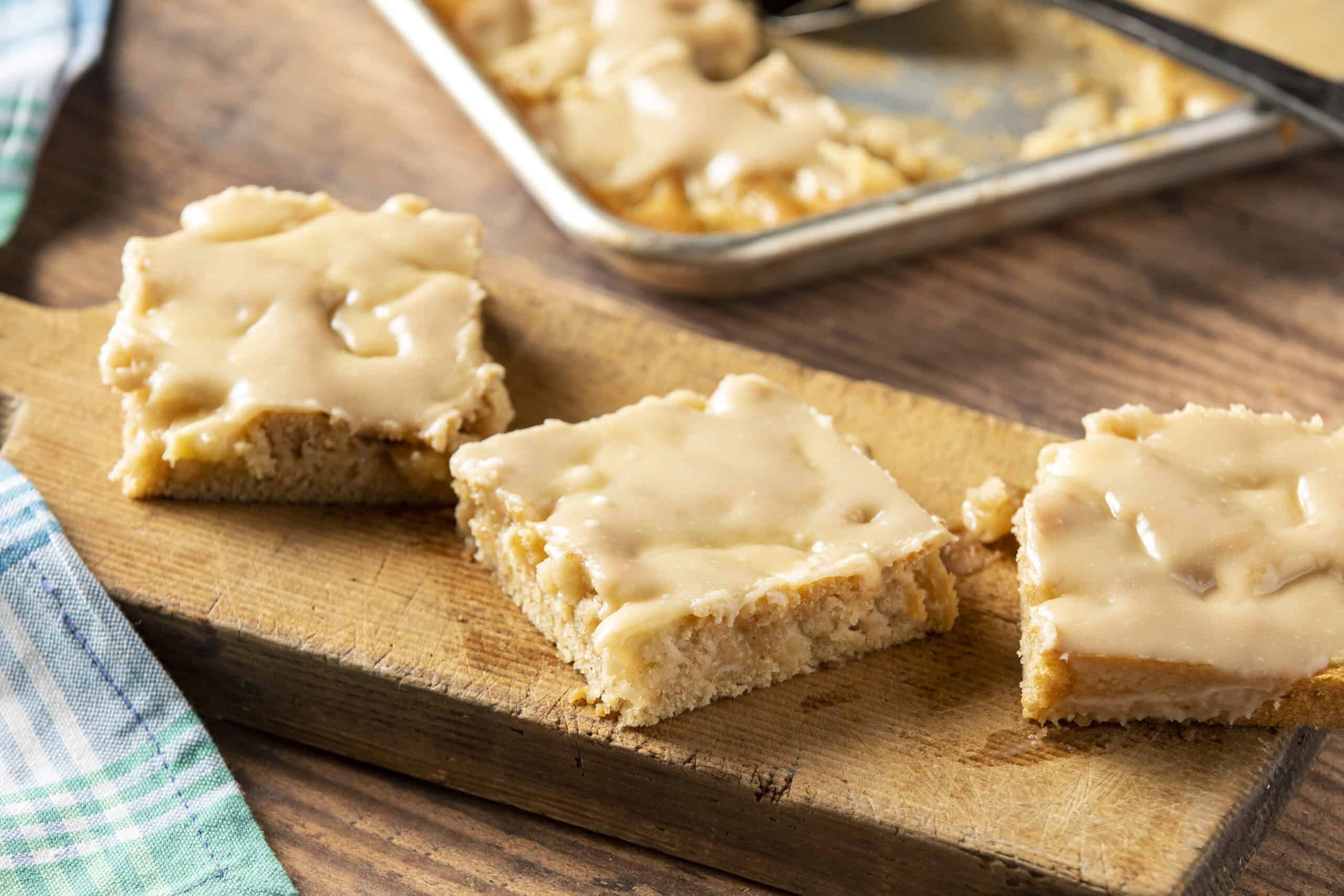 Butterscotch Blondie Squares with White Chocolate Drizzle on Wooden Cutting Board - Perfect for Easy Dessert Recipes.