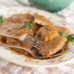 Succulent beef ribs covered in rich gravy served on a floral plate with fresh cilantro garnished. Perfect for hearty comfort food or a flavorful dinner, easy to prepare with simple ingredients.
