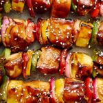 Skewers with grilled chicken and colorful vegetables topped with sesame seeds, ready for serving or grilling. Healthy and delicious skewers perfect for a summer barbecue or family dinner.