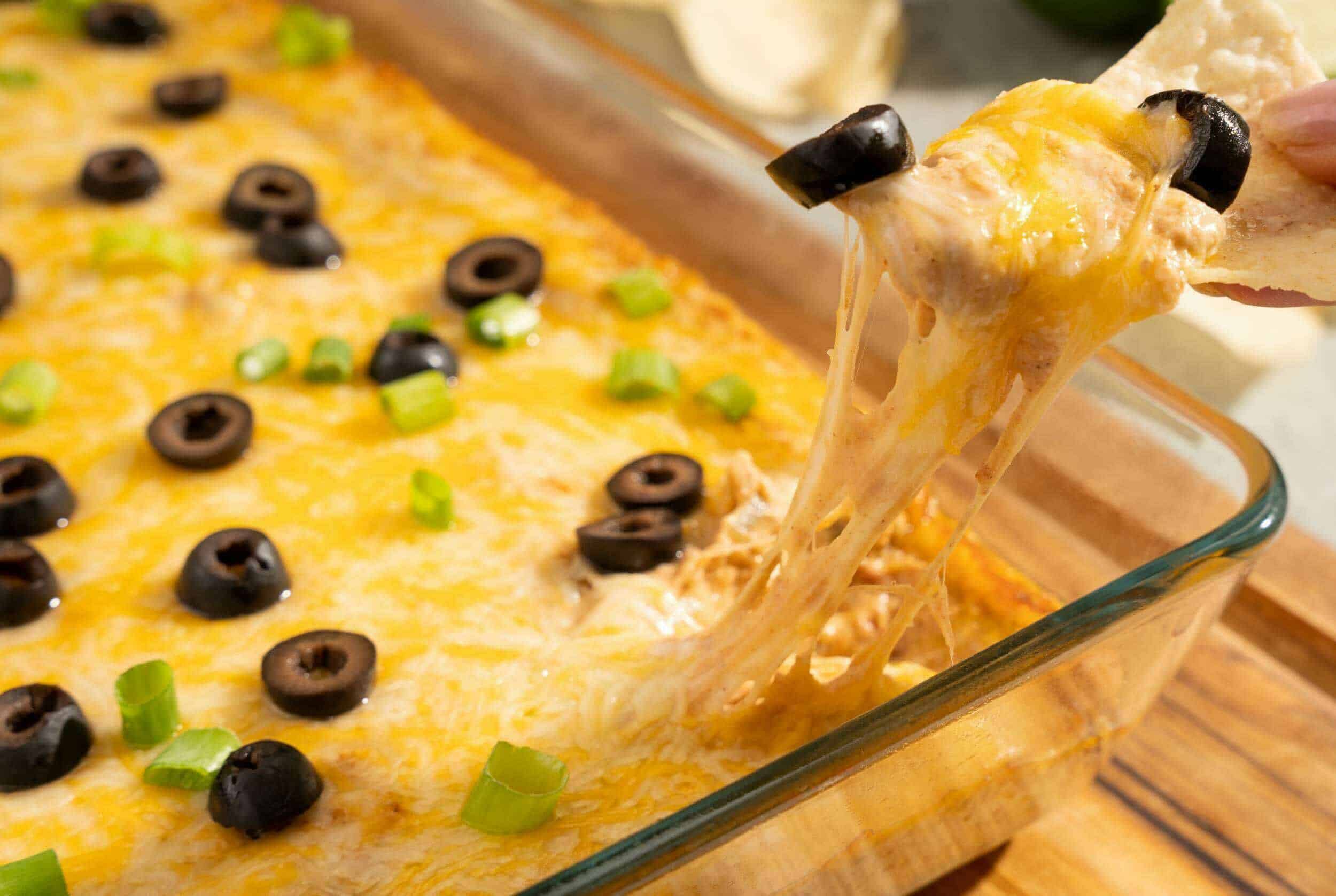 Golden cheesy baked dip with black olives and green onions, cheesy pull apart cheese dip, melted cheese appetizer, easy party food, cheesy baked appetizer.