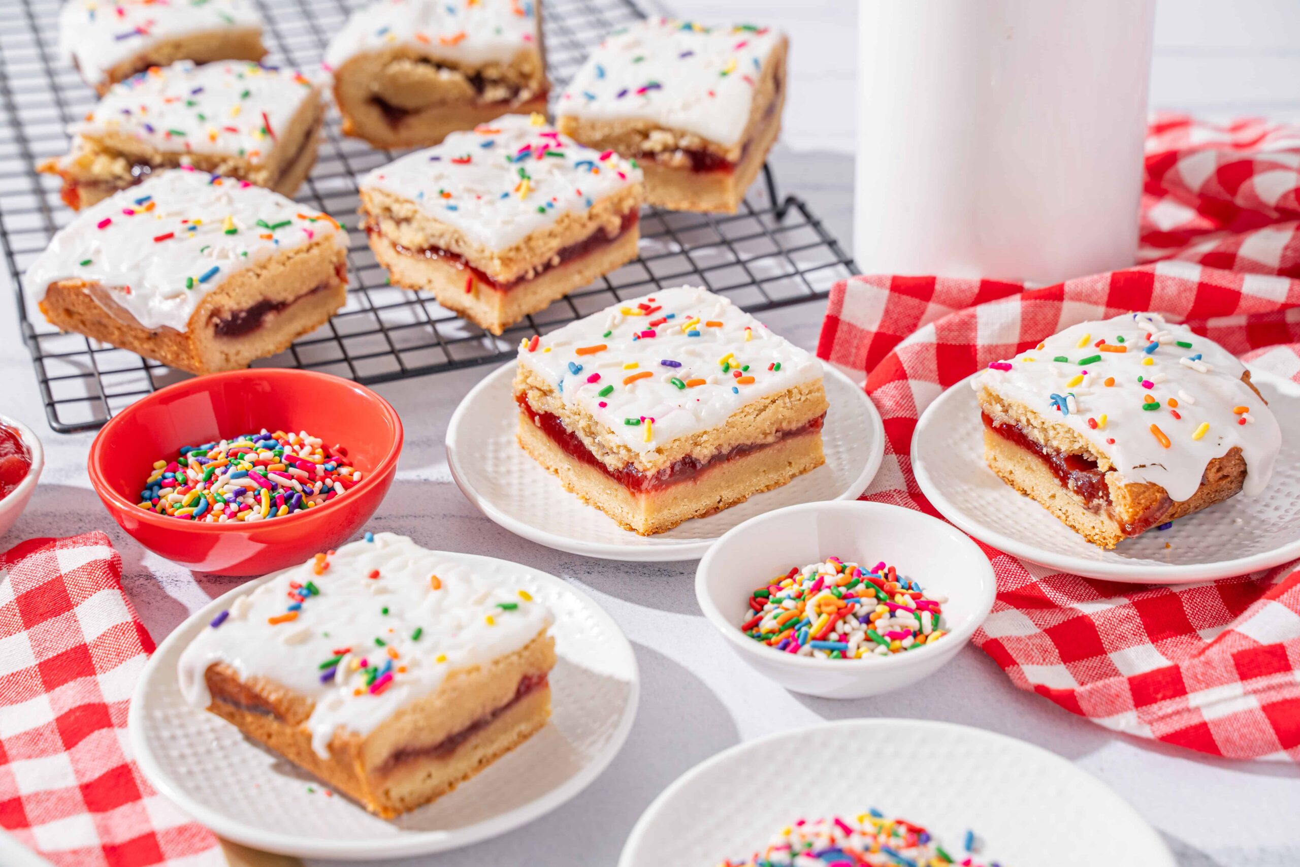 Colorful frosted sugar cookies with sprinkles and fruity filling, perfect for birthday parties and celebrations.