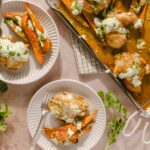 Creamy chicken and roasted carrots served with cilantro sauce on white plates, fresh cilantro garnish, and a baking dish with tender chicken pieces in rich sauce, perfect for dinner.