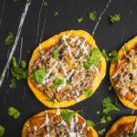 Savory taco ingredients inside crispy corn tortillas topped with cheese and fresh cilantro. Perfect for easy homemade tacos, meal prep, or taco night, featuring seasoned ground beef and melted cheese on a dark background.