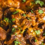 Slow cooker beef stew with tender beef chunks, carrots, potatoes, and herbs in rich, savory gravy, perfect for hearty comfort food meals.