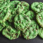 Bright green homemade chocolate chip cookies with a soft, chewy texture and gooey chocolate chunks, perfect for a tasty snack or dessert. Great for chocolate lovers and cookie recipes.