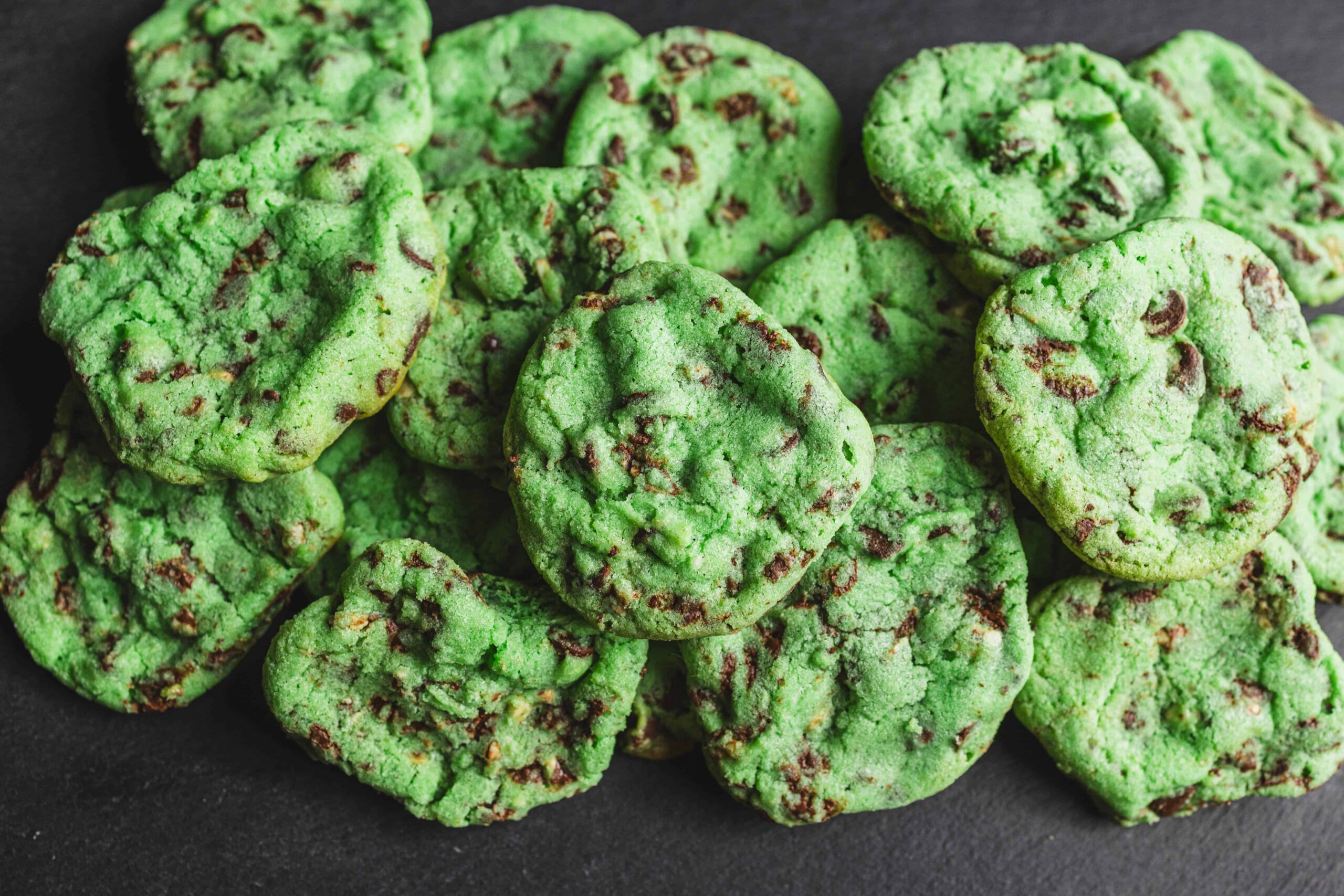 Bright green homemade chocolate chip cookies with a soft, chewy texture and gooey chocolate chunks, perfect for a tasty snack or dessert. Great for chocolate lovers and cookie recipes.