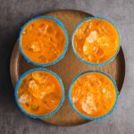 Sweet and tangy mango margaritas with salted rim, served in blue sugar-coated glasses, perfect for summer parties and outdoor celebrations.