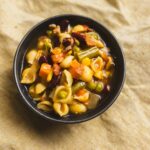 Creamy vegetable pasta soup with pasta shells, carrots, peas, corn, kidney beans, and celery in a broth. Healthy, hearty, and flavorful vegetable soup perfect for any season.