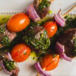 Juicy beef and vegetable skewers with cherry tomatoes, red onions, and fresh herbs, grilled to perfection. Ideal for healthy BBQ recipes and outdoor cooking.