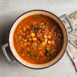 Savory homemade chili in a rustic pot with beans, ground meat, and vegetables, perfect for comforting meals and easy dinner ideas.