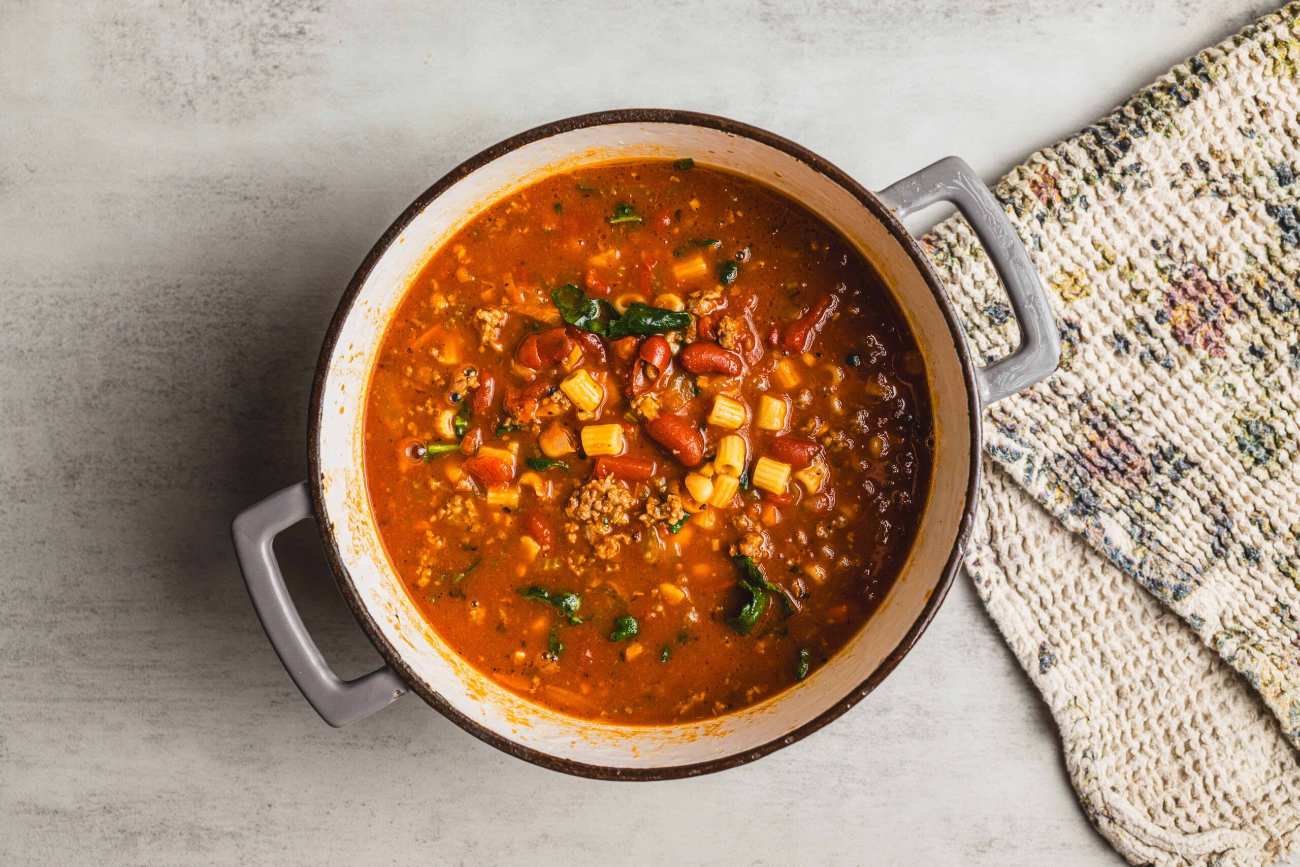 Savory homemade chili in a rustic pot with beans, ground meat, and vegetables, perfect for comforting meals and easy dinner ideas.