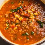 Rich beef chili with kidney beans, tomatoes, and spices in a cooking pot, perfect for hearty comfort food and easy dinner recipes.