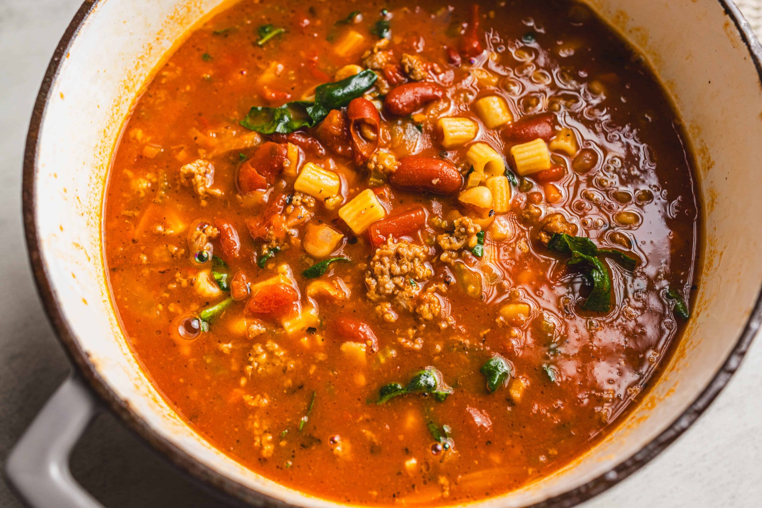Rich beef chili with kidney beans, tomatoes, and spices in a cooking pot, perfect for hearty comfort food and easy dinner recipes.